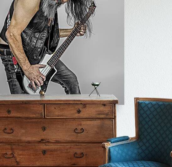 man with long hair playing the electric bass guitar. by Gualtiero Boffi