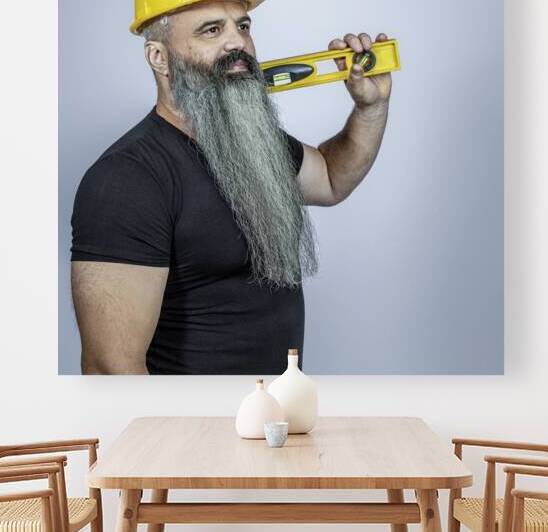 worker with helmet and spirit level. by Gualtiero Boffi