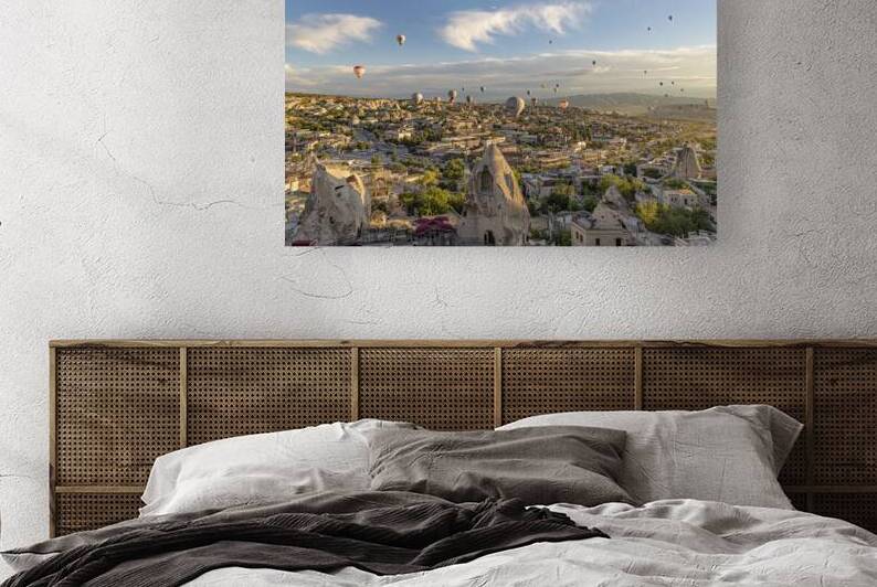 ot air balloon flies low over the city of goreme  by Gualtiero Boffi