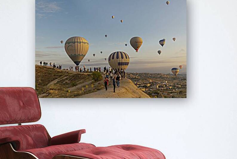hot air balloon flies low over the city of goreme  by Gualtiero Boffi