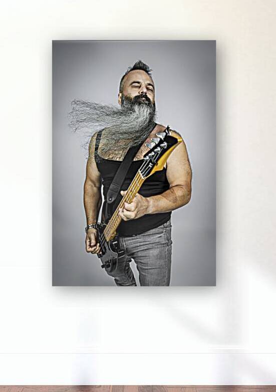 rocker with guitar and long beard plays with his eyes closed.  by Gualtiero Boffi