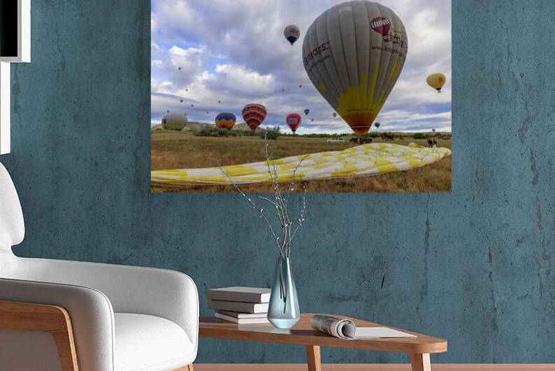 hot air balloons land near goreme at the end of the tour. by Gualtiero Boffi