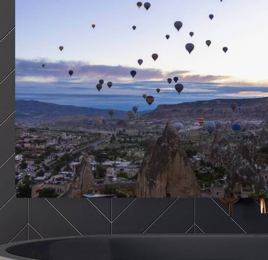 several hot air balloons fly at dawn in the sky of goreme by Gualtiero Boffi