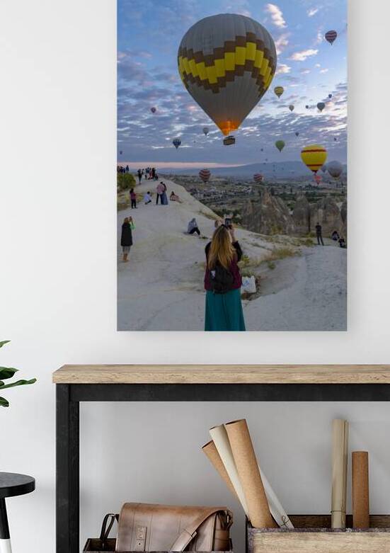 hot air balloon flies near the tourists . by Gualtiero Boffi