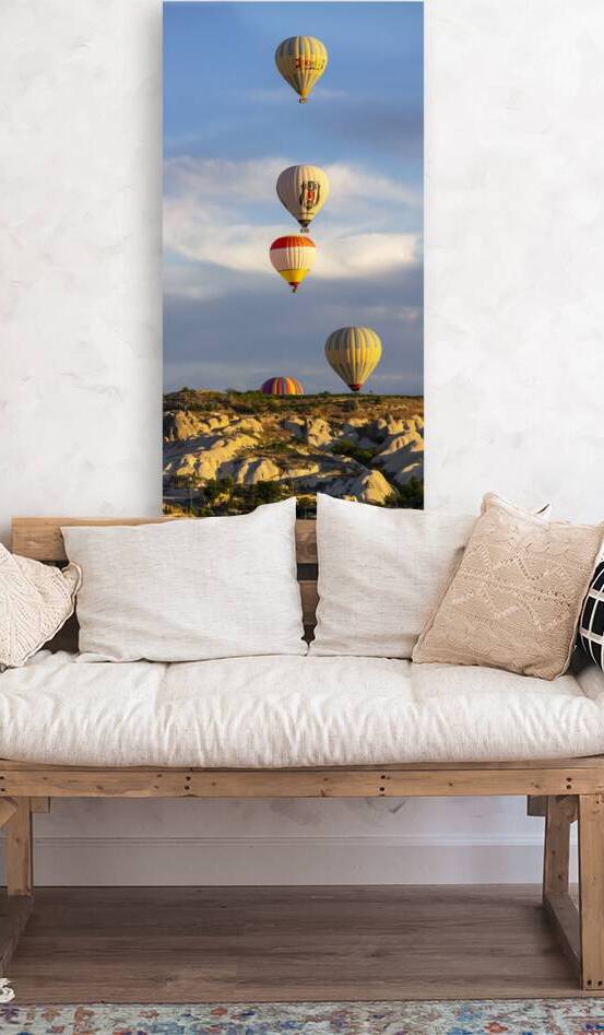 group of hot air balloons fly near Goreme at sunrise. by Gualtiero Boffi