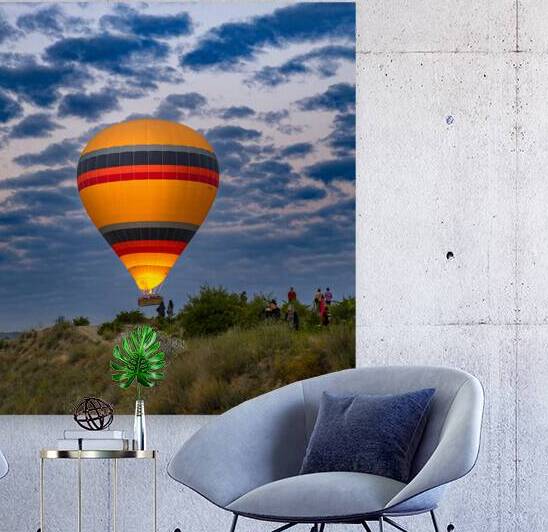 hot air balloon flies over the tourists near the hills of goreme by Gualtiero Boffi