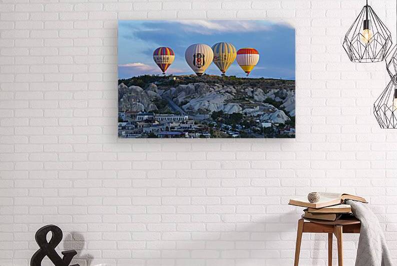 hot air balloons fly over the city of goreme.  by Gualtiero Boffi