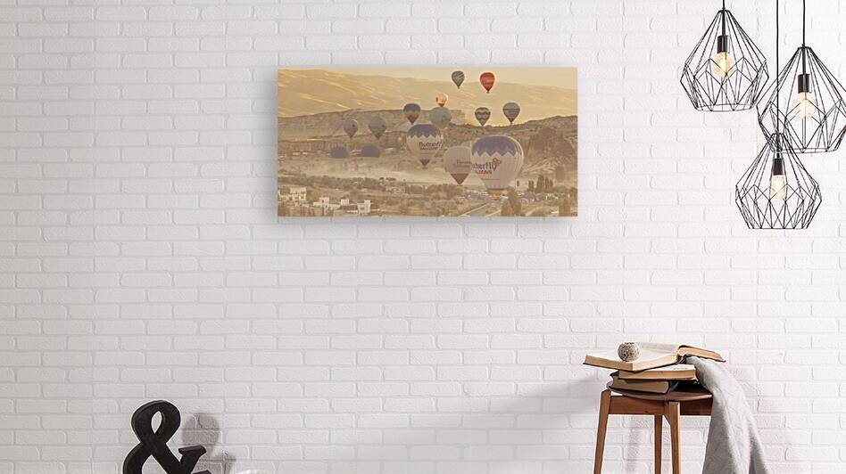 hot air balloon flies low over the city of goreme by Gualtiero Boffi