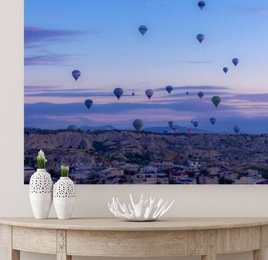 dozens of hot air balloons take off at dawn to transport tourist by Gualtiero Boffi