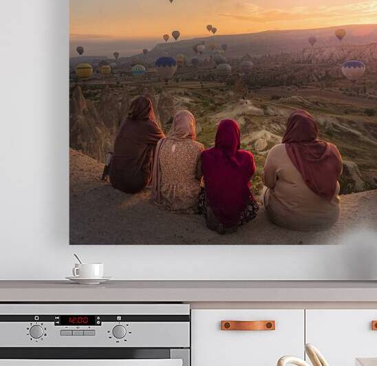 women in traditional dress watch hot air balloons  by Gualtiero Boffi