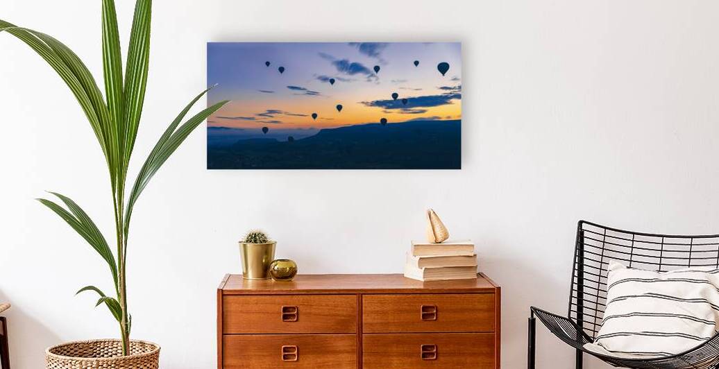 hot air balloons fly at sunrise over the city of Goreme  by Gualtiero Boffi