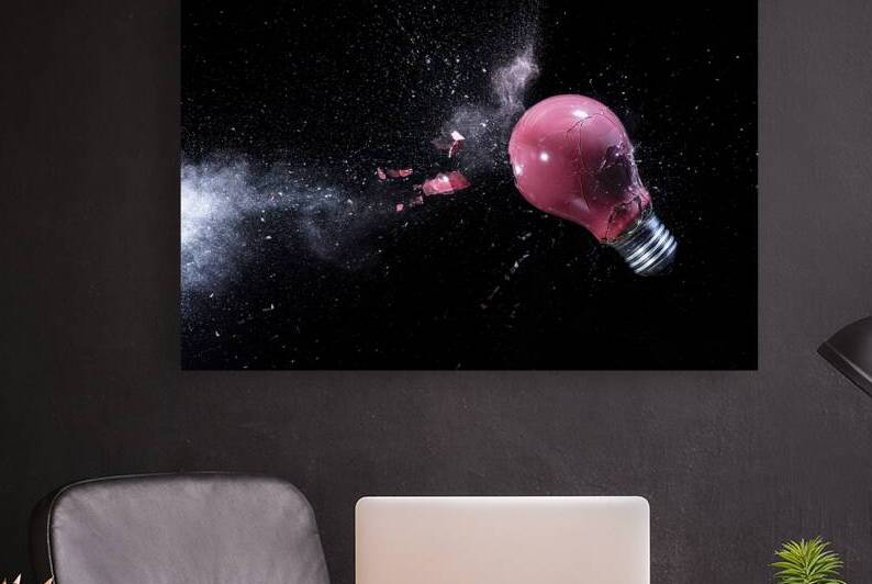 explosion of a red light bulb on black. by Gualtiero Boffi