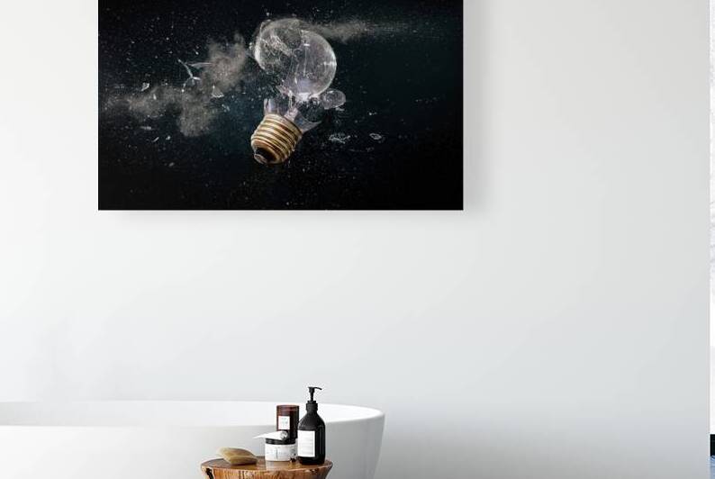 destruction of a light bulb on black. by Gualtiero Boffi