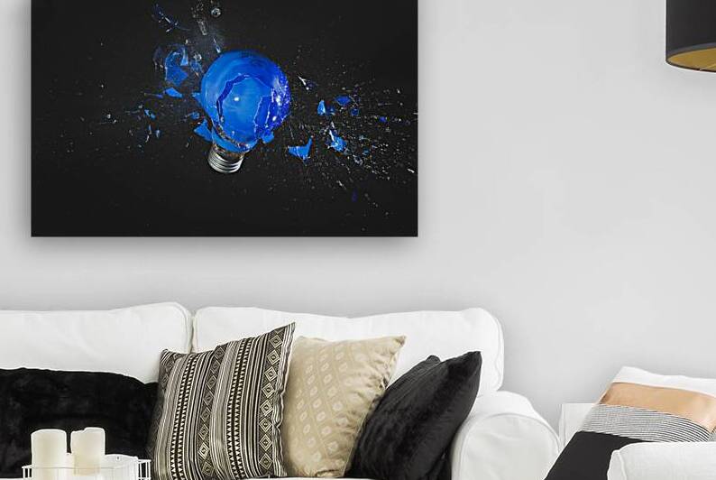 blue light bulb exploding on black.  by Gualtiero Boffi