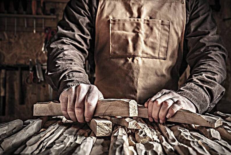 carved wood in hands by Gualtiero Boffi
