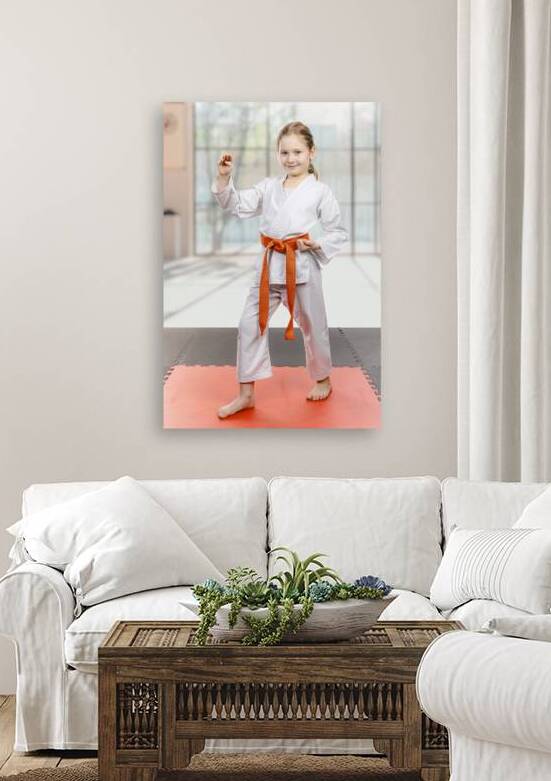 Young karate girl with orange belt posing by Gualtiero Boffi