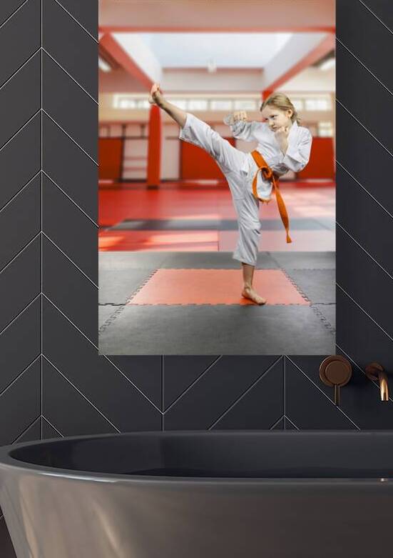 Young karate girl practicing high kick in dojo by Gualtiero Boffi