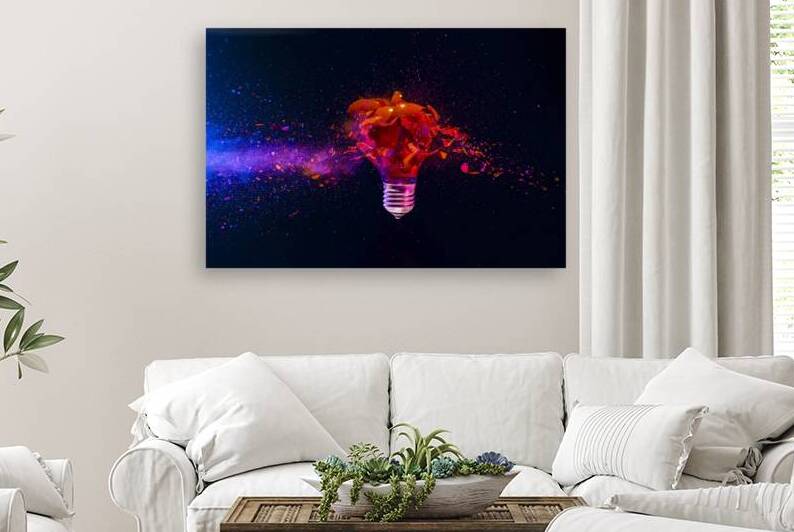 Red light bulb exploding with colorful powder on dark background by Gualtiero Boffi