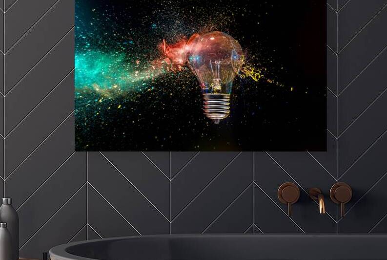Light bulb exploding with colorful powder  by Gualtiero Boffi