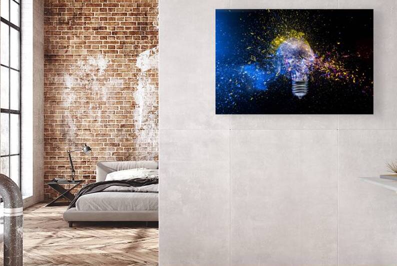 Light bulb exploding in colorful powder on black background by Gualtiero Boffi