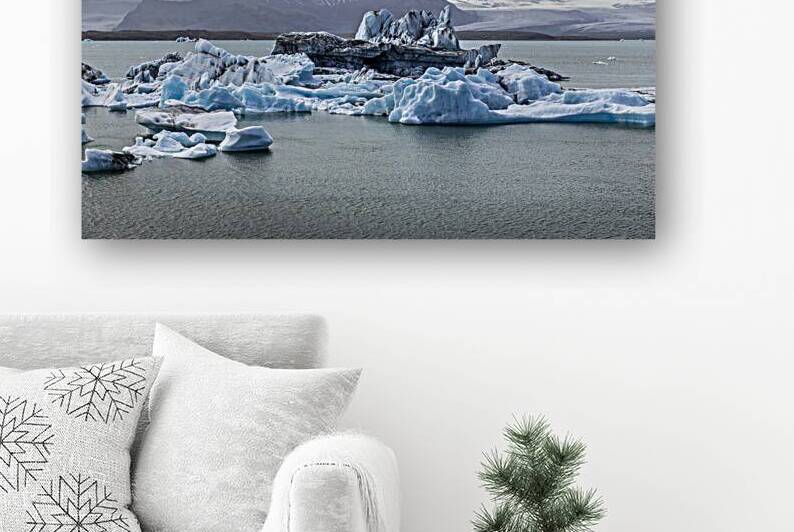 Icebergs floating on jokulsarlon glacier lagoon with mountains i by Gualtiero Boffi