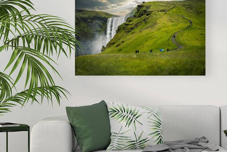 Tourists walking up path with waterfall and green grass in icela by Gualtiero Boffi