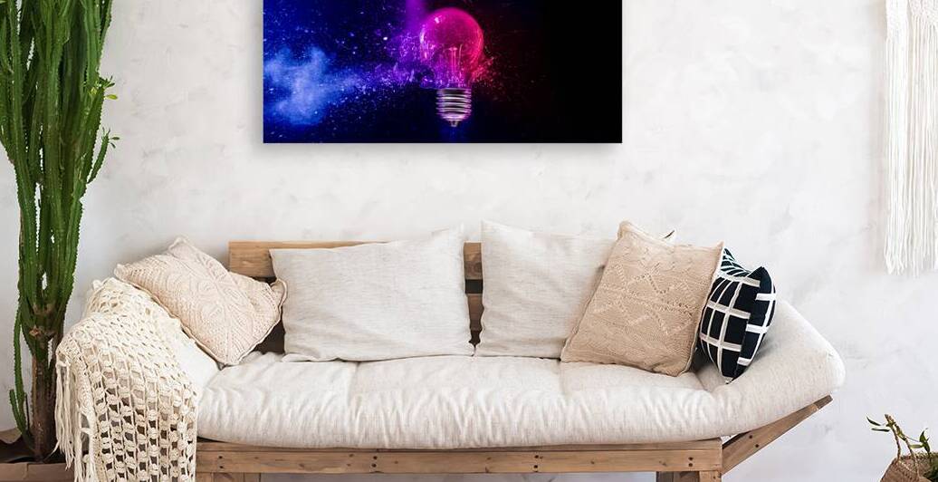 Pink light bulb exploding in colorful powder on black background by Gualtiero Boffi