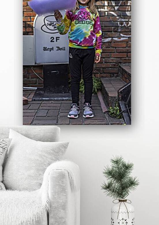 Smiling girl holding huge multicolored cotton candy by Gualtiero Boffi