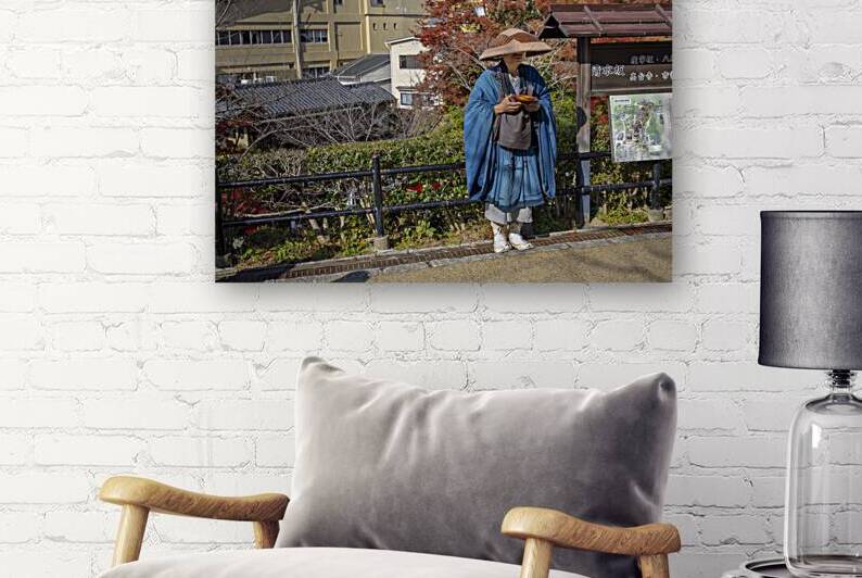 Buddhist monk holding a bowl standing near a sign in japan by Gualtiero Boffi