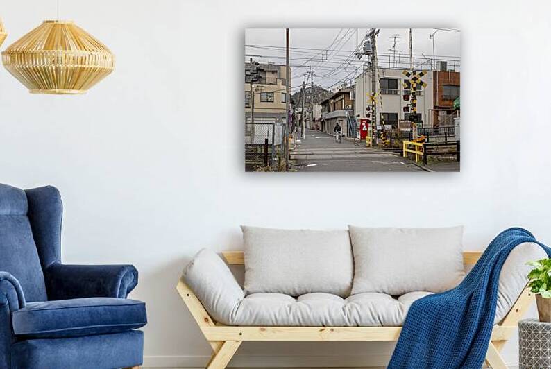 Man riding bicycle approaching japanese railroad crossing  by Gualtiero Boffi