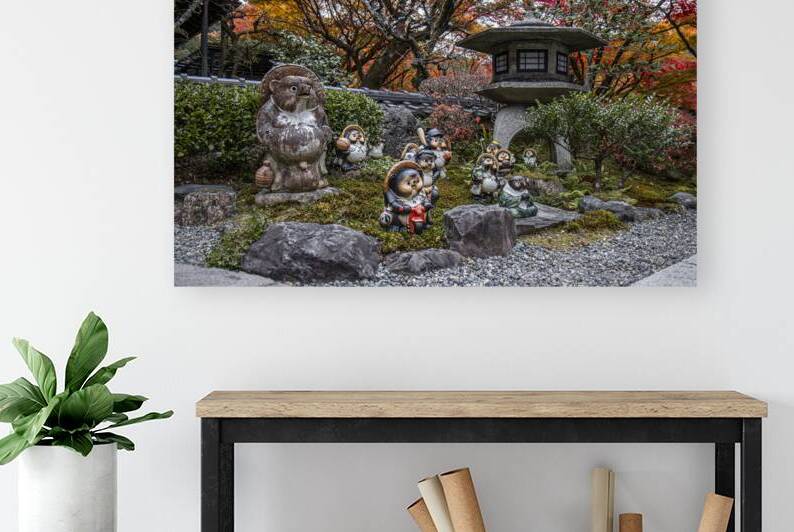 Tanuki statues guarding japanese garden during autumn by Gualtiero Boffi