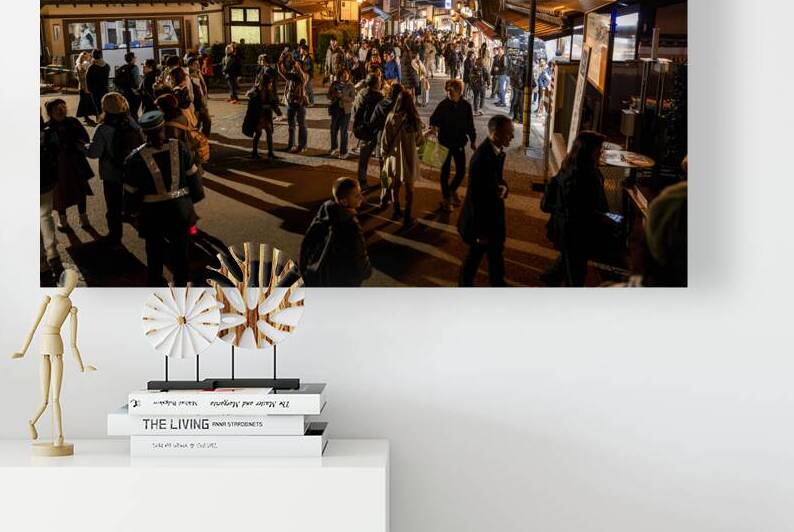 Crowd walking in a busy illuminated street at night in japan by Gualtiero Boffi