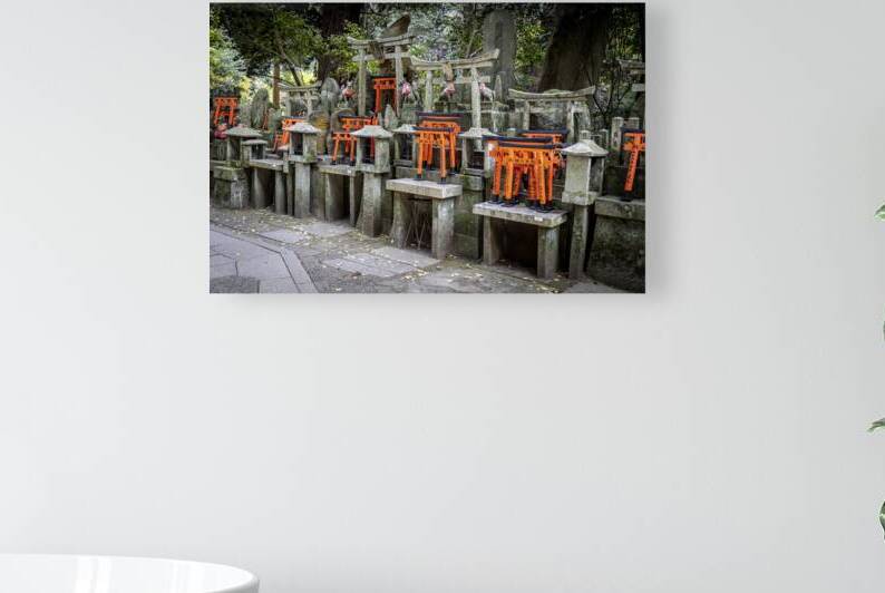 Many bright orange torii gates crowding a stone wall at fushimi  by Gualtiero Boffi