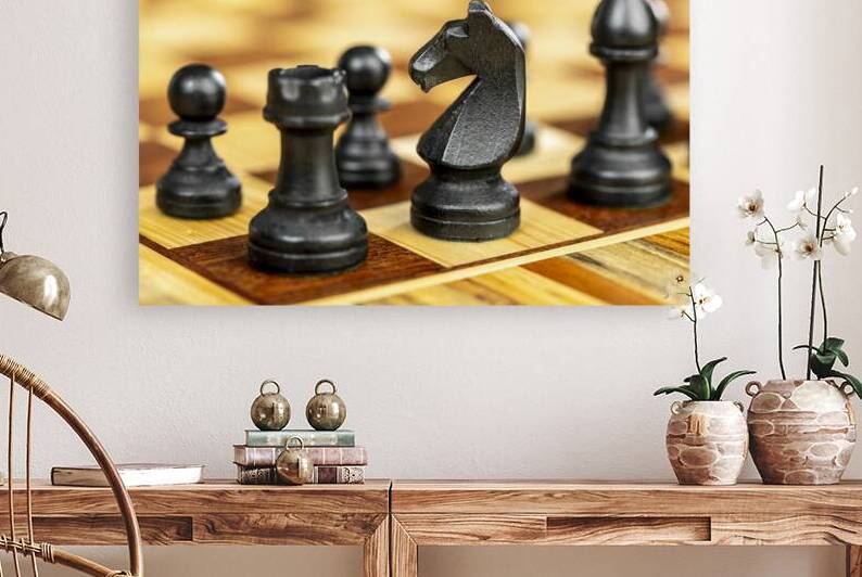 black knight chess piece on a wooden chessboard by Gualtiero Boffi