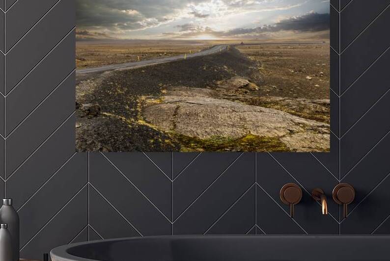 winding asphalt road crossing a vast otherworldly volcanic terr by Gualtiero Boffi