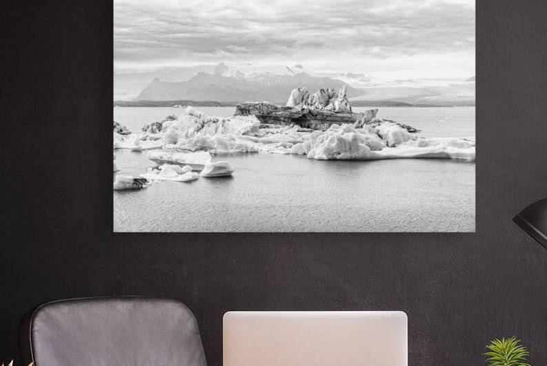 Icebergs floating on jokulsarlon glacier lagoon with mountains i by Gualtiero Boffi