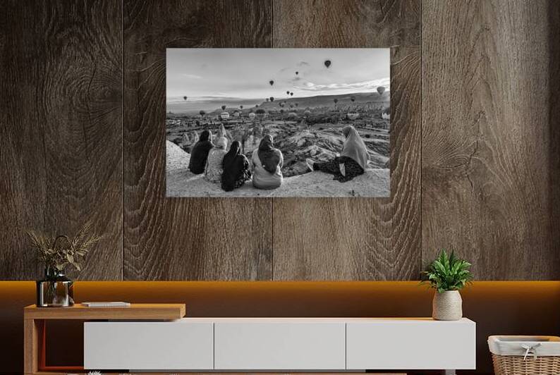Muslim women watching hot air balloons rising over cappadocia  by Gualtiero Boffi