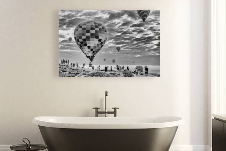 Tourists watching hot air balloons floating over cappadocia at s by Gualtiero Boffi