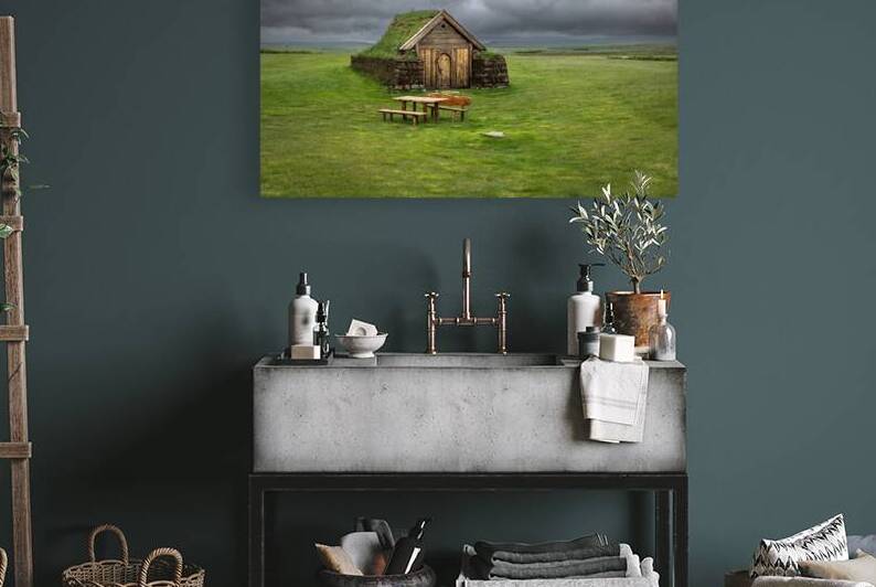 church house with grass roof in iceland cloudy sky by Gualtiero Boffi