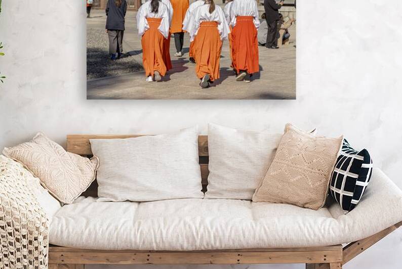 Group of miko walking wearing orange hakama and white haori by Gualtiero Boffi
