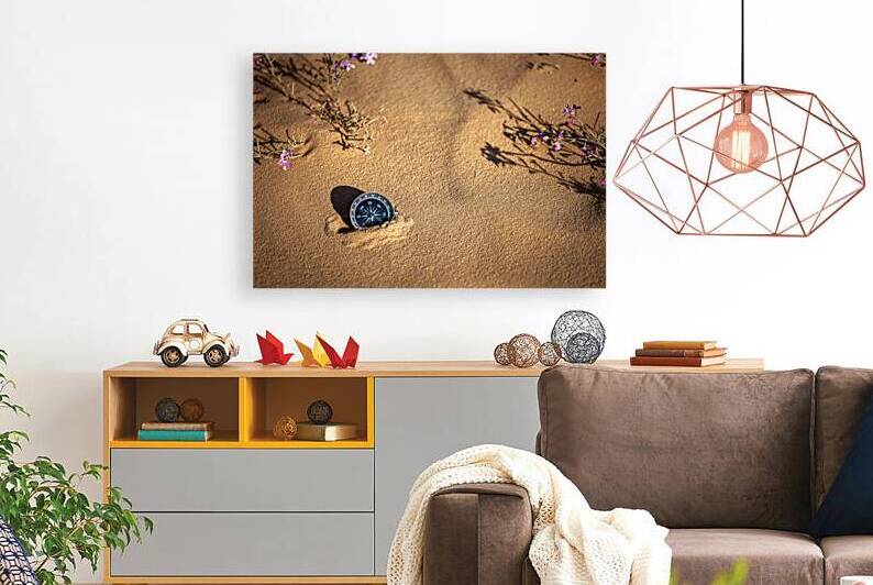 Magnetic compass guiding through vast desert sands adorned with by Gualtiero Boffi