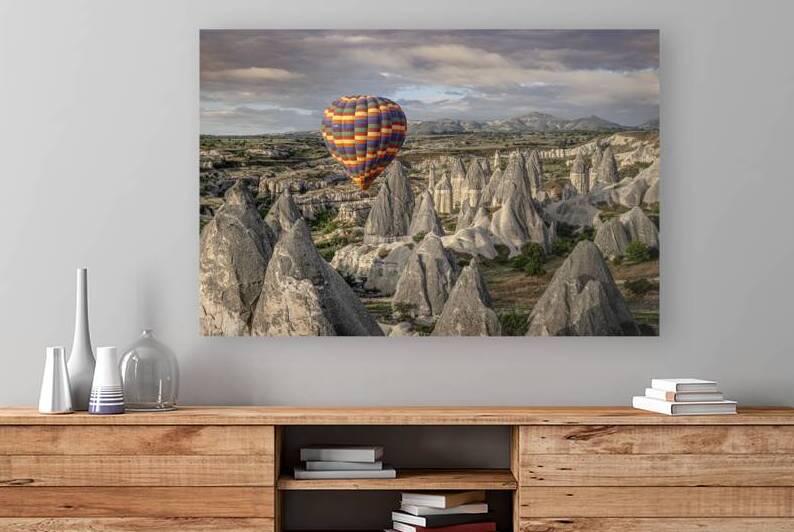 Colorful hot air balloon flying over the unique rock formations  by Gualtiero Boffi