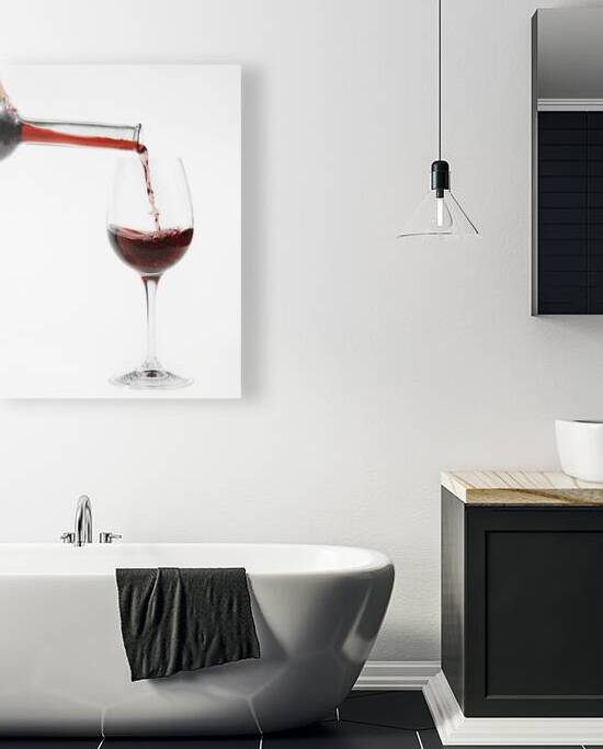 Pouring red wine into glass by Patricia Hofmeester PHotography