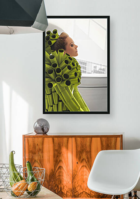 Side view of a beautiful young blonde woman with her eyes closed wearing a coat made of empty green toilet paper rolls in a bright  white minimalist decor by Artmood Visualz