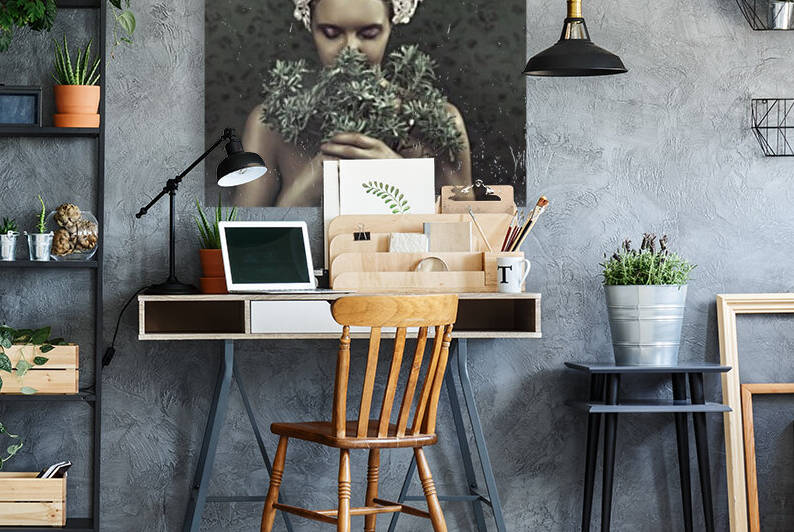 Beautiful young blonde woman with a traditional tembleque headdress holding flowers towards her face in front of a grey flower pattern wallpaper by Artmood Visualz