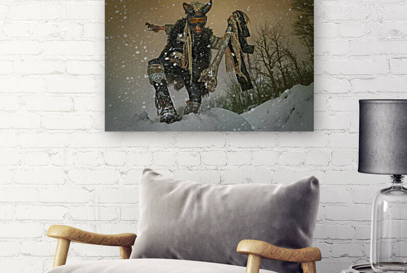 Tribal costumed person with a beastly appearance acting impressively with his stick standing in an apocalyptic looking snowstorm by Artmood Visualz