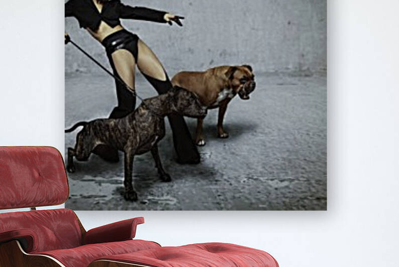 Beautiful and sexy blonde woman with slick back hair wearing a leather muzzle holding back an agressive dog while standing beside another one ordering to attack while pointing in front of her by Artmood Visualz