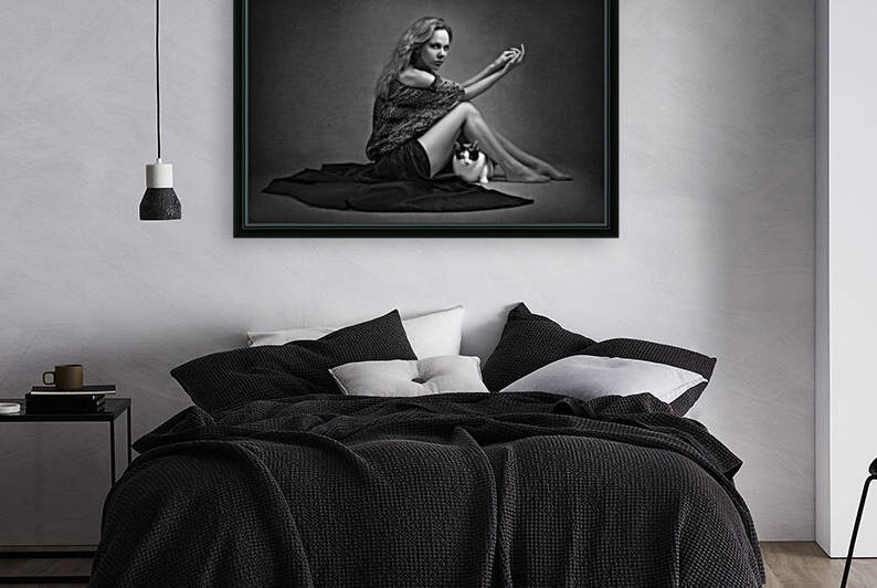 Black and white portrait of a beautiful young woman with a long black skirt sitting on the floor with her domestic cat both looking at the camera by Artmood Visualz