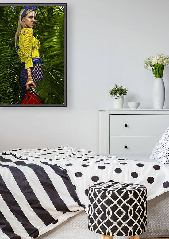 Beautiful young blonde woman wearing a colorful summer outfit holding a red djembe on the edge of a jungle by Artmood Visualz