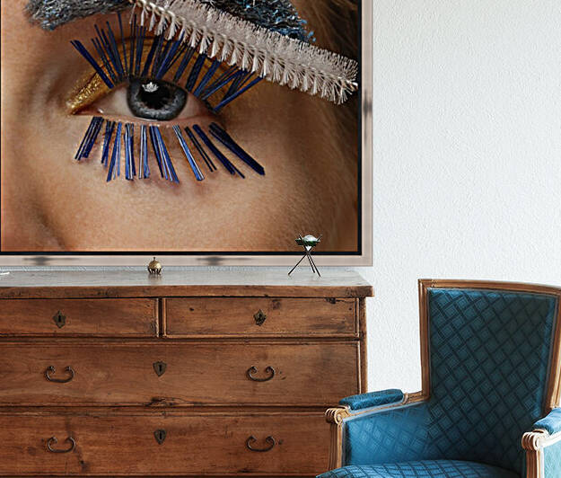 Close-up of a womans blue eye with a cleaning brush as a mascara applicator blue bristles as eyelashes	and her eyebrow made out of a scrubber by Artmood Visualz